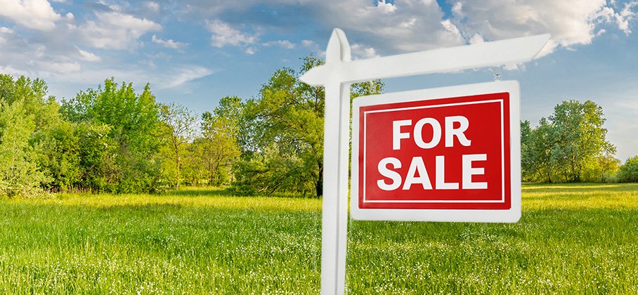 For sale sign on land