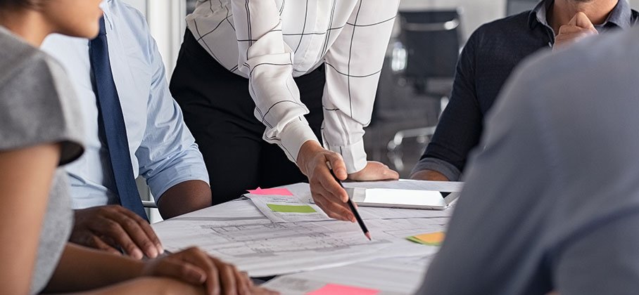 Group of people at a table looking of application