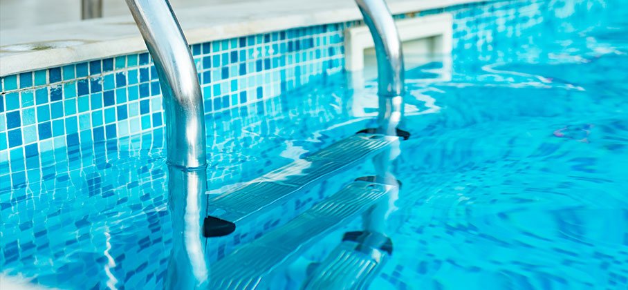 A silver ladder in a pool used to get out