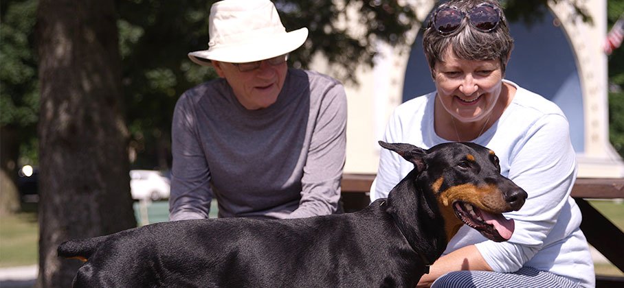 Dog with owners in Memorial Park Port Hope