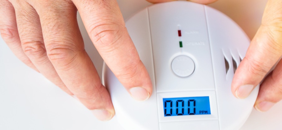 Fingers Holding Carbon Monoxide Alarm