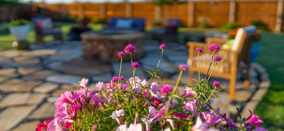 Spring Fire Safety Spring flowers in the foreground with a fire pit in the background