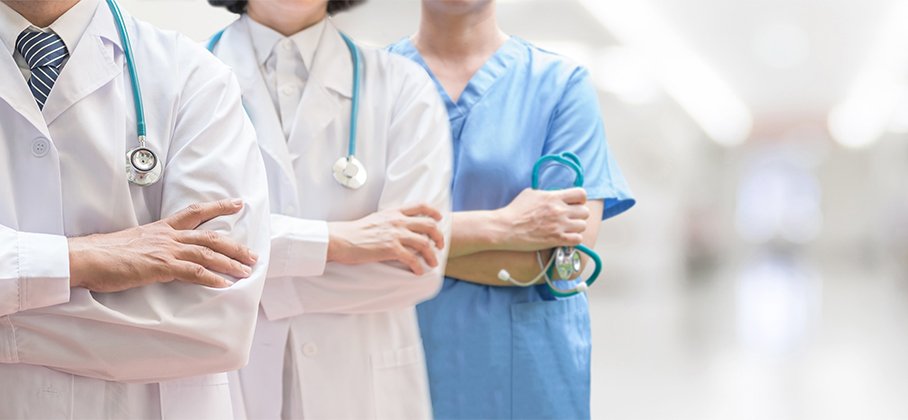 Health Care professionals in white coats with arms crossed