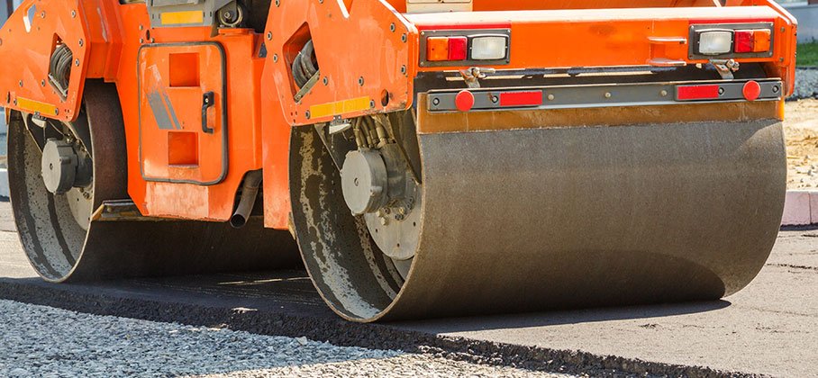 Road Equipment compacting newly laid asphalt
