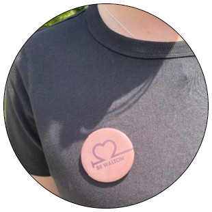 Pink Button with words Be Walton in blue