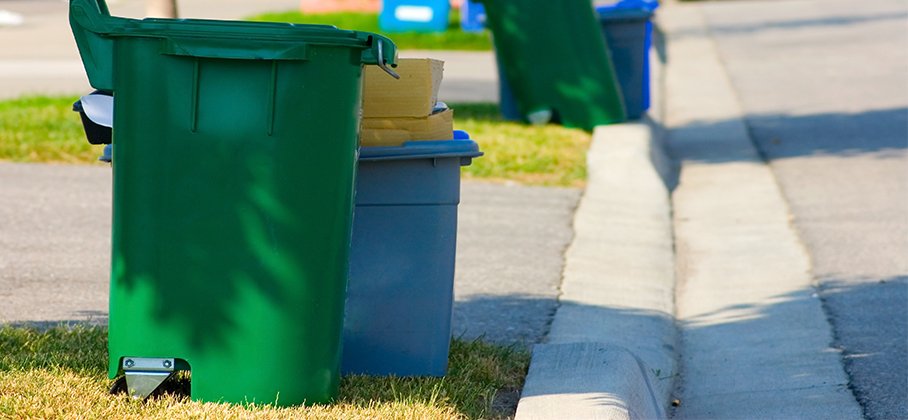 Garbage bins at on the curb with street 