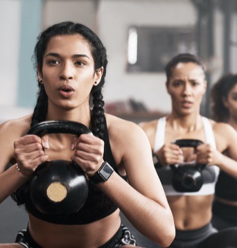 Image of fitness class participants using kettle bells