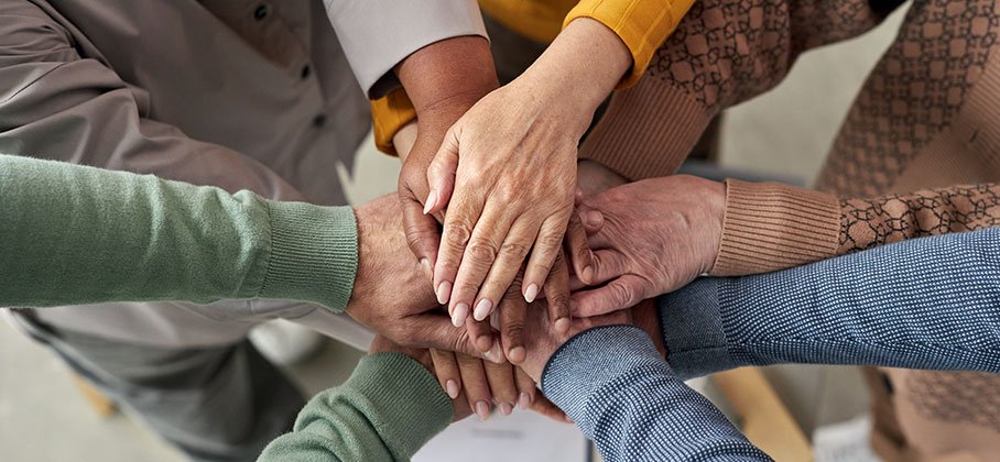 Group of seniors in a group huddle