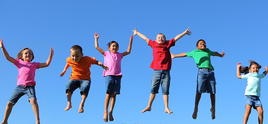 Group of friends jumping outside