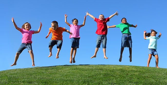 Kids jumping on the grass