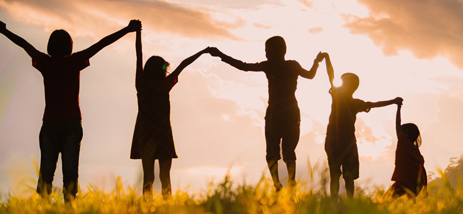 Group holding hands in a field
