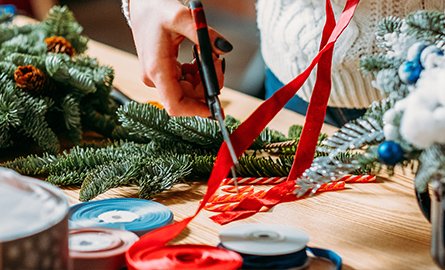Person cutting Christmas ribbon