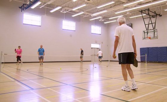 town park recreation centre gym and group playing pickleball
