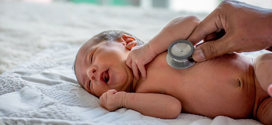 Newborn Infant laying on it's side getting check-up