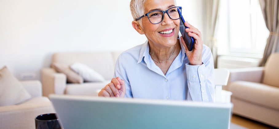 Woman on laptop and on phone