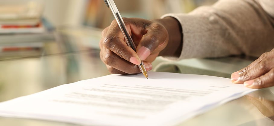 Hand of someone signing a document